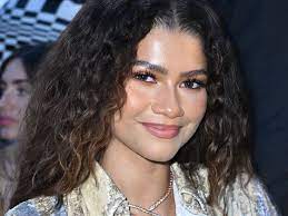 Zendaya in a red carpet event, radiating confidence and style.